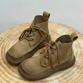 Detailed view of vintage tan leather Martin boots with thick soles and round toes. - 35 / Khaki Fleece Lined