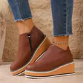 Detailed view of women's brown wedge platform ankle boots with a stylish side zipper - 36 / Brown
