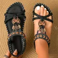 Close-up of bohemian flat sandals with ethnic beads and rhinestone details on feet. - 38 / Graphite Black
