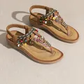 Detailed view of bohemian style women's flat sandals with colorful ethnic beads - 36 / Caramel color