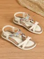 Detailed view of beige Bohemian flat sandals with colorful bead and floral accents - 36 / Off White