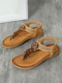 High quality detail of bohemian flat sandals with colorful beadwork and tassel accents - 36 / Caramel color