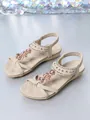 Close-up of beige Bohemian flat sandals with floral beading and metallic stud details. - 36 / Apricot
