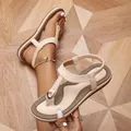 Close-up of beige Bohemian thong sandals with elastic ankle strap and gold hardware. - 35 / Off White