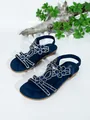 Detail view of navy blue Bohemian flat sandals with sparkling rhinestone floral motifs. - 35 / Navy Blue