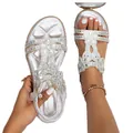 Macro view of silver Bohemian flat sandals decorated with intricate rhinestones. - 36 / Silver