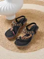 Bohemian platform wedge sandals with beaded straps and heart charms on a woven rug. - 36 / Black