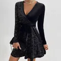 Detail view of the sparkly silver sequin pattern on a black V-neck long-sleeved dress - S / Dresses / Black