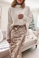 Elegant rose gold sequin midi skirt styled with a cozy cream oversized sweater in a room - S / Bottoms / Gold