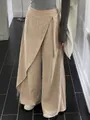 High waisted wide leg khaki trousers featuring an asymmetrical wrap belt and buckle detail - S / Bottoms / Khaki