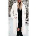 Elegant long white teddy plush coat with lapels worn in a winter snowy forest scene. - S / Tops / White