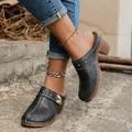 Detailed view of black vintage carved mules with chunky heels and floral patterns - 36 / Black