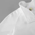 Detailed view of white women's trench coat featuring collar and raglan sleeve seam - S / Tops / White