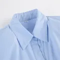 Close-up detail view of a classic light blue cotton shirt collar with visible M size tag - S / Tops / Blue