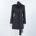 Detail view of a navy pinstripe two-piece suit set featuring a blazer and mini skirt - S / Top And Bottom / Navy Blue