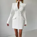 Detailed close-up of a white slim-fit blazer dress with high neck and button accents - S / Dresses / White