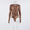 Detailed front view of women's leopard print long sleeve knit bodysuit on mannequin - S / Tops / Leopard Print