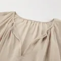 Close-up detail of the V-neckline and sheer fabric texture on a khaki chiffon dress - S / Khaki