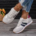 Detail view of breathable women's sneakers with blue stripes and maroon heel accent. - 36 / Navy Blue