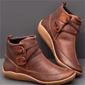 Vintage brown leather flat ankle boots with decorative buttons and wrap-around straps - 35 / Brown