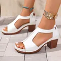 Macro view of white peep-toe wedge sandals with wood-textured chunky heel and T-strap. - 36 / White