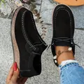 Detailed view of women's black suede loafers featuring white stitching and wood grain platform soles - 40 / Solid Black