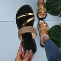 Detailed view of women's black flat slippers with gold straps and sparkling rhinestones - Black with Gold