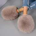 Close-up of oversized fluffy mauve fur slippers worn with blue distressed jeans. - 36-37 / Khaki