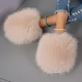 Close-up of plush oversized faux fur slippers in soft peach with warm winter lining - 36-37 / Off White
