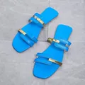 Detailed macro view of stylish blue flat sandals featuring elegant gold metallic strap accents - 36 / Teal