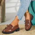 Brown patent leather loafers with tassel and bow detail on a black platform lug sole. - 38 / Bow Tassel Style (988.1) / Coffee