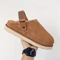 Macro view of brown suede platform clogs featuring an adjustable ankle strap and thick sole. - 36 / Dark Brown