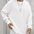 Detail shot of the texture of a white mesh knit sweater with a loose oversized fit and crew neck. - M / Tops / White