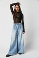 Full length view of women's light blue wide-leg pleated denim jeans in street style - S / Bottoms / Light Blue