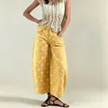 Detailed view of yellow polka dot wide-leg curved jeans for women in casual daily style - S / Bottoms / Yellow