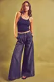 Close-up showing the relaxed fit and washed texture of high-waisted wide-leg jeans - Black