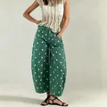 Close-up detail of green polka dot wide-leg cropped denim jeans for a stylish casual look - Dark Green