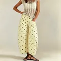Detailed view of women's yellow polka dot wide-leg barrel jeans and lace top ensemble. - S / Bottoms / Light Yellow