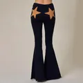 High-waisted black flare jeans with distinctive brown star patches on back pockets - S / Bottoms / Black