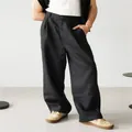 Macro detail view showing the texture and pleats of black wide-leg linen casual trousers for men - S / Black