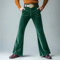 Detailed view of men's emerald green velvet flared trousers with a vintage style - S / Bottoms / Green
