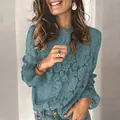 Close-up detail of a teal lace blouse featuring intricate hollow-out floral patterns - 3XL / Tops / Blue