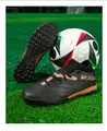 Detailed side view of black seamless fly-knit soccer shoes with turf cleats - Black Gold Turf
