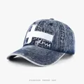 Washed denim baseball cap featuring an embroidered white cross for urban streetwear fashion - Adjustable / Denim Blue