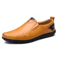 Close-up detail of tan leather loafers with hand-stitched seams and rubber sole. - 37 / Yellow