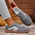 Macro detail view of retro grey suede casual sneakers with vintage wood background - 36 / Gray