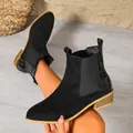Side view of stylish black suede Chelsea boots with crocodile texture heel detail - Black