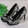 Macro detail of black lace high heels featuring elegant rhinestone bow on a square toe design. - 34 / Beige