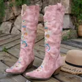 Detailed view of pink embroidered high-tube western cowboy boots on wooden deck - 36 / Pink