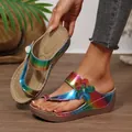 Close-up detail of rainbow metallic wedge sandals featuring 3D flower and toe-loop. - Blue Floral